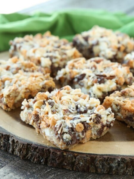 Seven Layer Bars, magic cookie bars, kitchen sink bars, whatever you call them, this classic dessert is easy and delicious. A graham cracker crust, chocolate, white chocolate, and butterscotch chips, nuts, and shredded coconut are melded together with sweetened condensed milk.