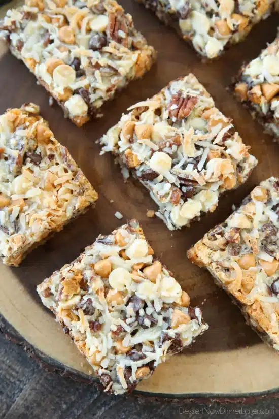 Seven Layer Bars, magic cookie bars, kitchen sink bars, whatever you call them, this classic dessert is easy and delicious. A graham cracker crust, chocolate, white chocolate, and butterscotch chips, nuts, and shredded coconut are melded together with sweetened condensed milk.