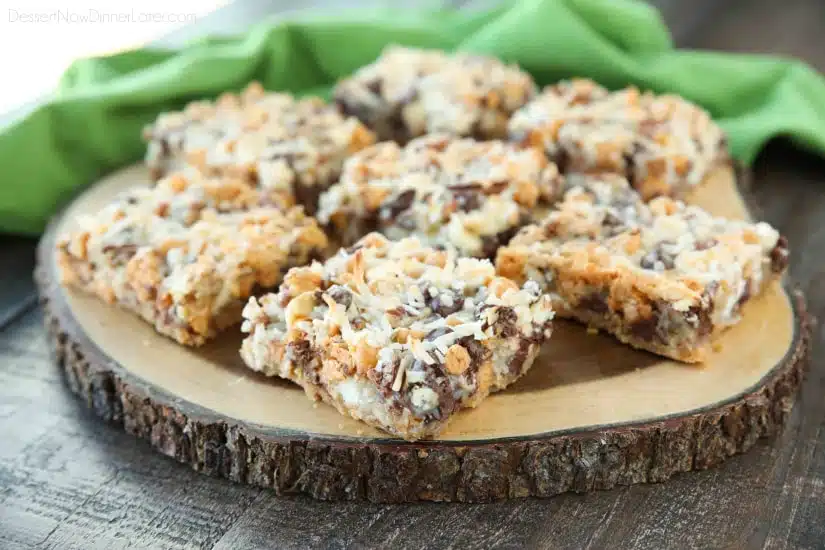 Seven Layer Bars, magic cookie bars, kitchen sink bars, whatever you call them, this classic dessert is easy and delicious. A graham cracker crust, chocolate, white chocolate, and butterscotch chips, nuts, and shredded coconut are melded together with sweetened condensed milk.