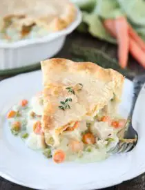 This classic Chicken Pot Pie is made from scratch with a creamy and flavorful chicken and vegetable filling tucked inside of a flaky pastry crust. Homemade comfort food that the whole family loves!