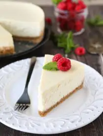 This Classic Cheesecake recipe is smooth, creamy, moist, and full of vanilla, with a graham cracker crust. Plus all the tips and tricks for the perfect cheesecake with no cracks! A great dessert for the holidays or any occasion.