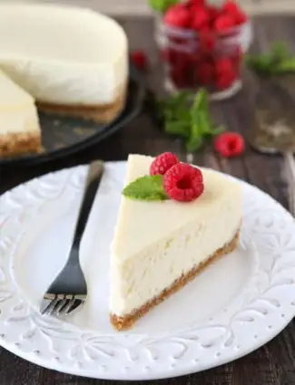 This Classic Cheesecake recipe is smooth, creamy, moist, and full of vanilla, with a graham cracker crust. Plus all the tips and tricks for the perfect cheesecake with no cracks! A great dessert for the holidays or any occasion.