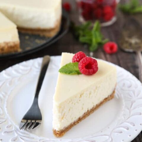 This Classic Cheesecake recipe is smooth, creamy, moist, and full of vanilla, with a graham cracker crust. Plus all the tips and tricks for the perfect cheesecake with no cracks! A great dessert for the holidays or any occasion.