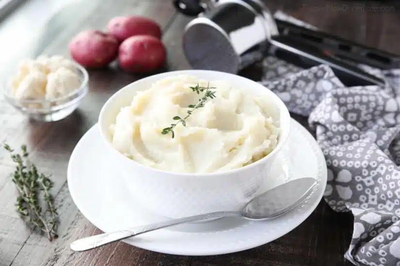 Lightened-up Creamy Cauliflower and Mashed Potatoes is a healthier side dish, with half cauliflower and half potatoes. Velvety smooth and creamy with less carbs and no milk, sour cream, or butter. Delicious enough for Thanksgiving or Christmas, yet simple enough for any dinner.