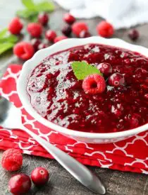 This easy raspberry cranberry sauce is sweet, tangy, and quick (only 4 ingredients & 15 minutes) to make! Uses fresh or frozen fruit, and is easy to make ahead of time. A classic for Thanksgiving or Christmas dinner.