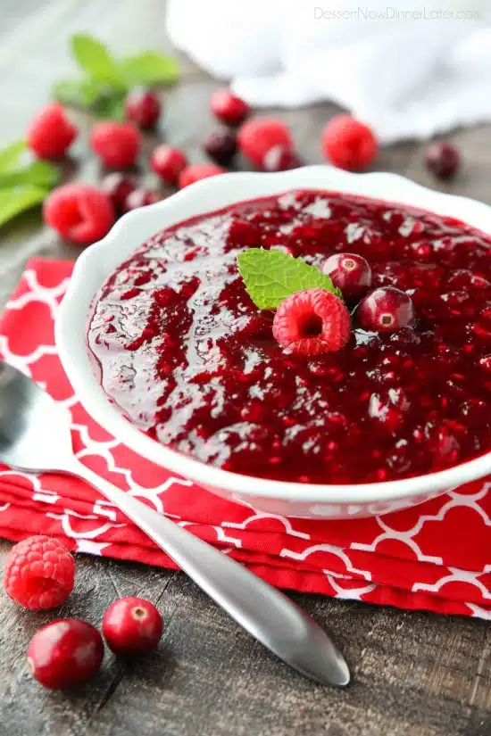 This easy raspberry cranberry sauce is sweet, tangy, and quick (only 4 ingredients & 15 minutes) to make! Uses fresh or frozen fruit, and is easy to make ahead of time. A classic for Thanksgiving or Christmas dinner.