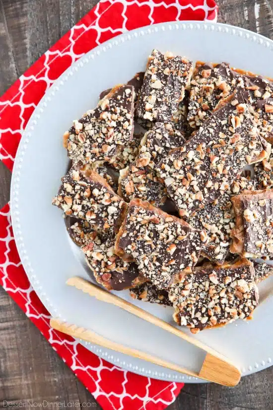 Cracker Toffee (aka Christmas Crack) is so easy to make and highly addictive! Saltine crackers are coated in a quick toffee layer and topped with chocolate and nuts. 