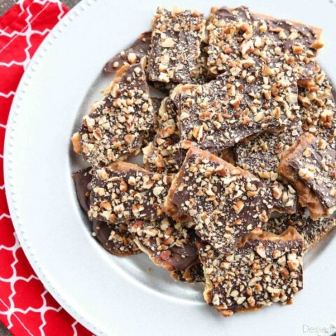 Cracker Toffee (aka Christmas Crack) is so easy to make and highly addictive! Saltine crackers are coated in a quick toffee layer and topped with chocolate and nuts. 