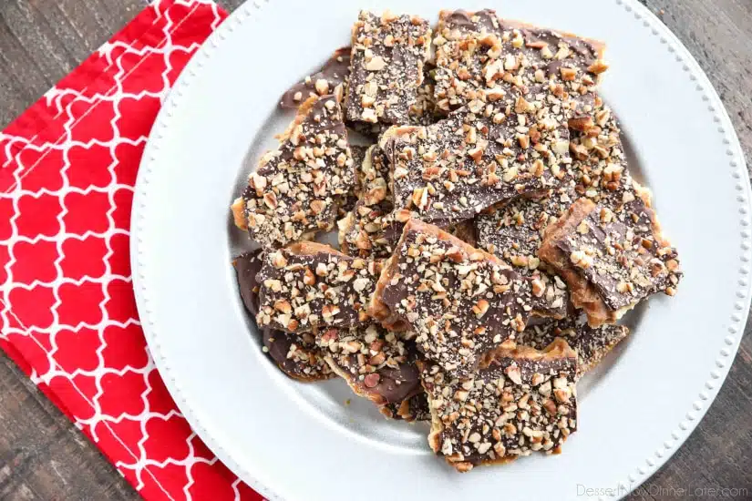 Cracker Toffee (aka Christmas Crack) is so easy to make and highly addictive! Saltine crackers are coated in a quick toffee layer and topped with chocolate and nuts. 