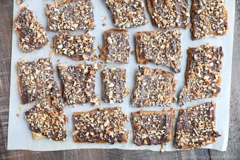 Cracker Toffee (aka Christmas Crack) is so easy to make and highly addictive! Saltine crackers are coated in a quick toffee layer and topped with chocolate and nuts. 