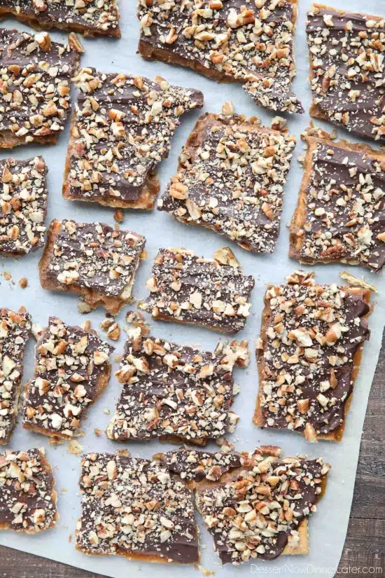 Cracker Toffee (aka Christmas Crack) is so easy to make and highly addictive! Saltine crackers are coated in a quick toffee layer and topped with chocolate and nuts. 