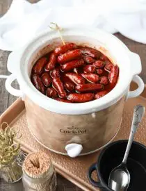 Crockpot Little Smokies is an easy appetizer for parties, the big game, or holidays. Only three ingredients and a slow cooker is all you need for these cocktail sausages. The sweet and tangy sauce is great on meatballs too! 