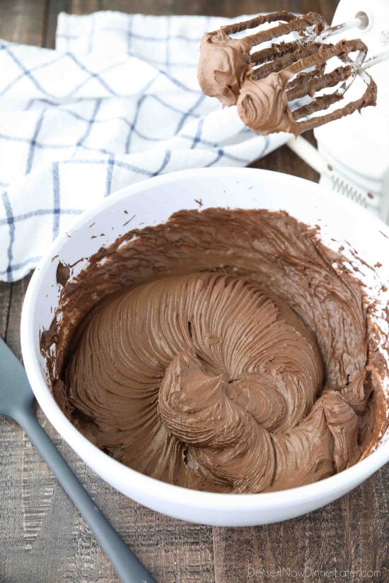 Chocolate cream cheese frosting made in bowl with hand mixer.