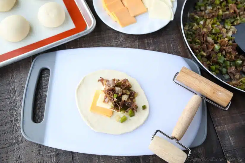 Yeast dough rolled into a circle with cheese and meat on top.