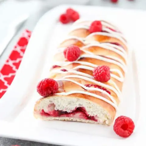 Raspberry Breakfast Braid - a quick raspberry sauce and cream cheese filling are stuffed inside this easy braided bread that's drizzled with a sweet and simple icing. A special breakfast or dessert for weekends or holidays with step-by-step pictures to help you make it.