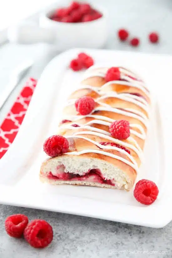 Raspberry Breakfast Braid - a quick raspberry sauce and cream cheese filling are stuffed inside this easy braided bread that's drizzled with a sweet and simple icing. A special breakfast or dessert for weekends or holidays with step-by-step pictures to help you make it.