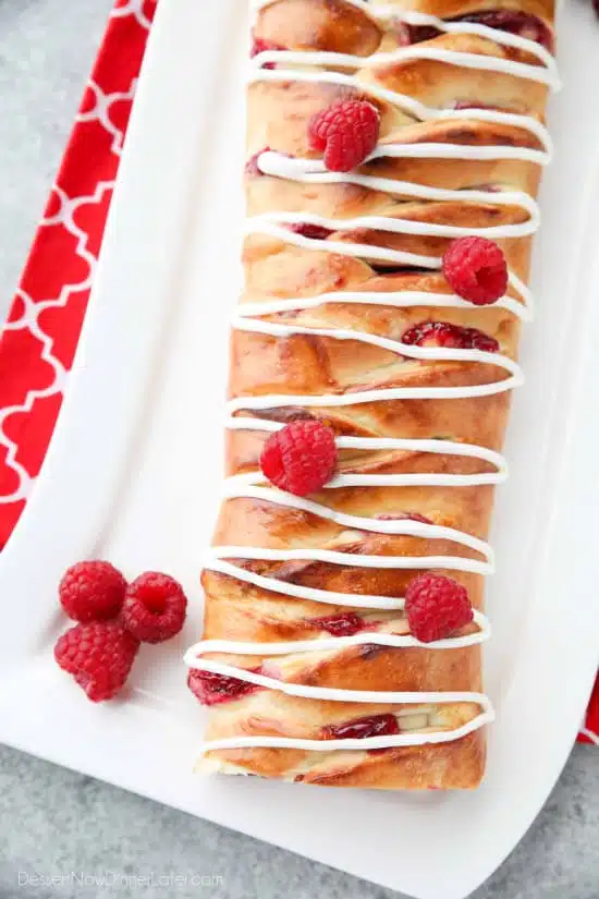 Raspberry Breakfast Braid - a quick raspberry sauce and cream cheese filling are stuffed inside this easy braided bread that's drizzled with a sweet and simple icing. A special breakfast or dessert for weekends or holidays with step-by-step pictures to help you make it.