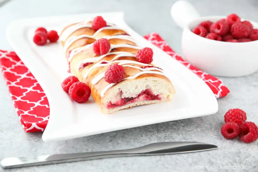 Raspberry Breakfast Braid - a quick raspberry sauce and cream cheese filling are stuffed inside this easy braided bread that's drizzled with a sweet and simple icing. A special breakfast or dessert for weekends or holidays with step-by-step pictures to help you make it.