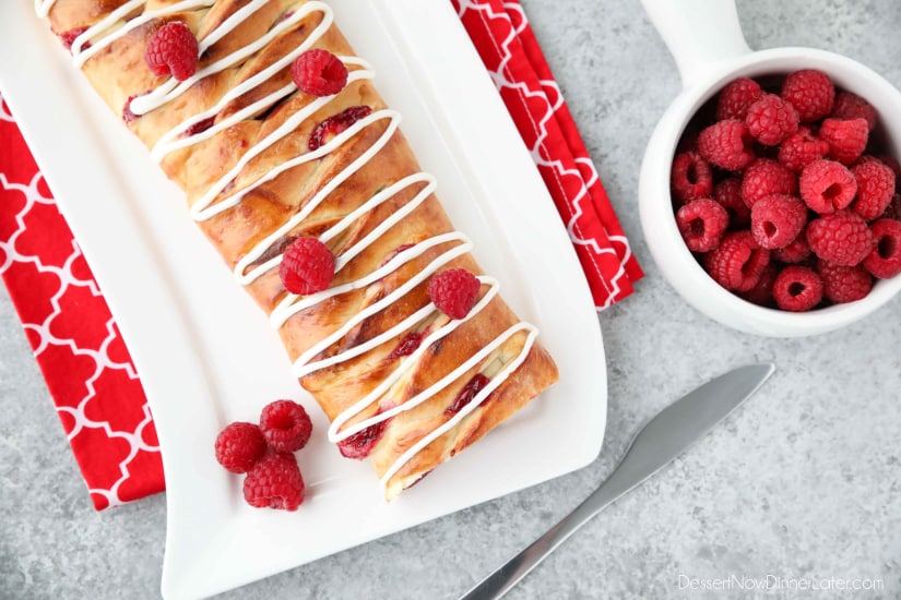Raspberry Breakfast Braid - a quick raspberry sauce and cream cheese filling are stuffed inside this easy braided bread that's drizzled with a sweet and simple icing. A special breakfast or dessert for weekends or holidays with step-by-step pictures to help you make it.