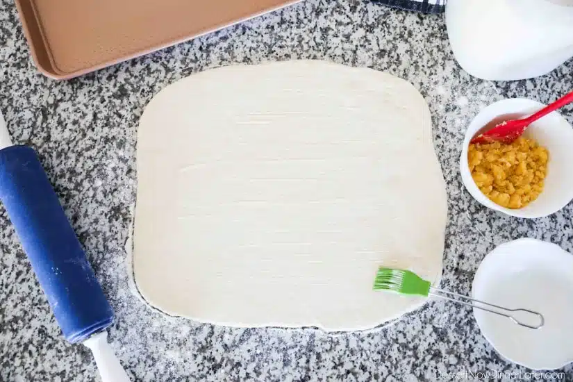 Orange Rolls - Roll dough into a rectangle, then brush softened butter on top.