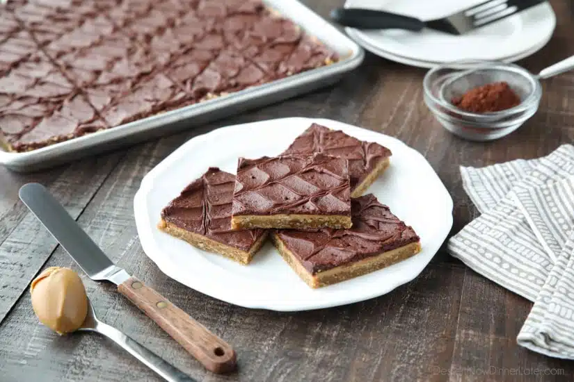 These Peanut Butter Bars with oatmeal are a soft and chewy baked cookie dessert topped with an extra layer of peanut butter, and a decadent chocolate frosting. Perfect for parties and potlucks! (Serves a crowd.)