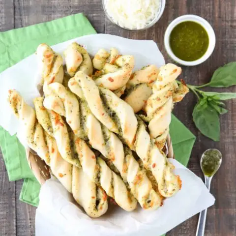 These easy Pesto Breadsticks are soft and flavorful with savory basil pesto and cheesy mozzarella twisted inside. A great appetizer or side for soup, salad, or pasta.﻿