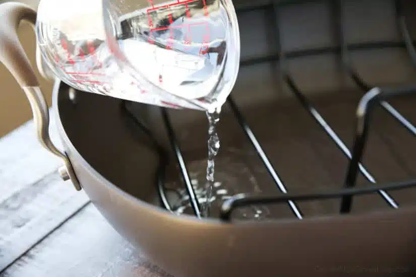 To cook ham, add water to the bottom of the roasting pan.