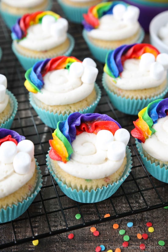 These Funfetti Rainbow Cupcakes are colorful inside and out! Homemade funfetti cupcakes are moist and full of sprinkles. Then topped with a colorful buttercream rainbow and mini marshmallow clouds. Super fun for birthday cupcakes or perfectly festive for St. Patrick's Day!