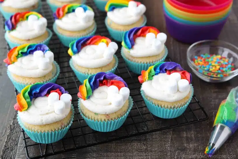 These Funfetti Rainbow Cupcakes are colorful inside and out! Homemade funfetti cupcakes are moist and full of sprinkles. Then topped with a colorful buttercream rainbow and mini marshmallow clouds. Super fun for birthday cupcakes or perfectly festive for St. Patrick's Day!