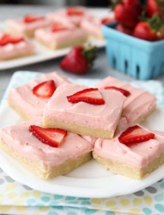 Strawberry Sugar Cookie Bars - soft, moist sugar cookie bars are topped with a natural strawberry frosting. Super easy to make and serves a crowd!