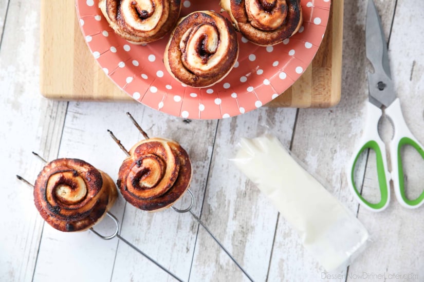 Campfire Cinnamon Rolls are cooked on a stick over a fire or grill. As easy as a can of biscuits, but with real yeast dough instead! The best cinnamon rolls you will ever have while camping!