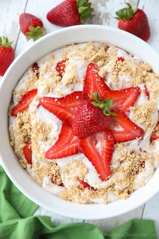 Strawberry Cheesecake Salad is loaded with cream cheese, jello pudding, yogurt, fresh strawberries, and whipped topping then sprinkled with a graham cracker crust. It's a delicious potluck salad, fluff salad, or decadent fruit salad that doubles as a dessert.﻿