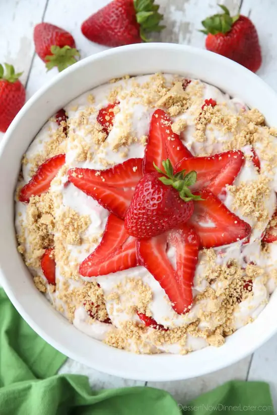 Strawberry Cheesecake Salad is loaded with cream cheese, jello pudding, yogurt, fresh strawberries, and whipped topping then sprinkled with a graham cracker crust. It's a delicious potluck salad, fluff salad, or decadent fruit salad that doubles as a dessert.