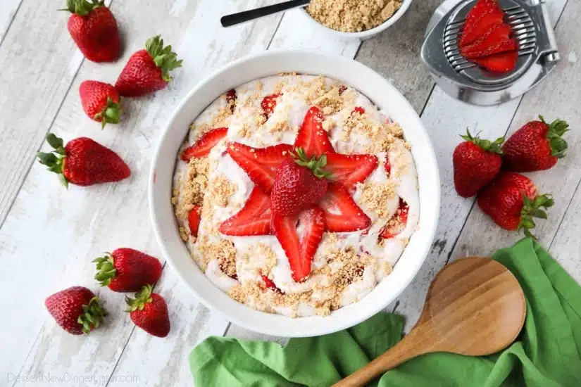 Strawberry Cheesecake Salad is loaded with cream cheese, jello pudding, yogurt, fresh strawberries, and whipped topping then sprinkled with a graham cracker crust. It's a delicious potluck salad, fluff salad, or decadent fruit salad that doubles as a dessert.