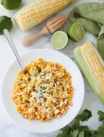 Mexican Street Corn Salad is easy, creamy, and packed with flavor! Your favorite roasted Mexican street corn (Elote) is cut off the cob (to make Esquites) and is served with a spoon, for a delicious summer side dish!