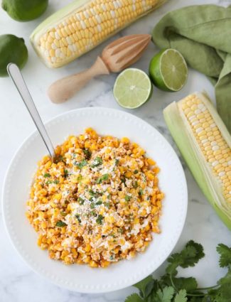 Mexican Street Corn Salad is easy, creamy, and packed with flavor! Your favorite roasted Mexican street corn (Elote) is cut off the cob (to make Esquites) and is served with a spoon, for a delicious summer side dish!