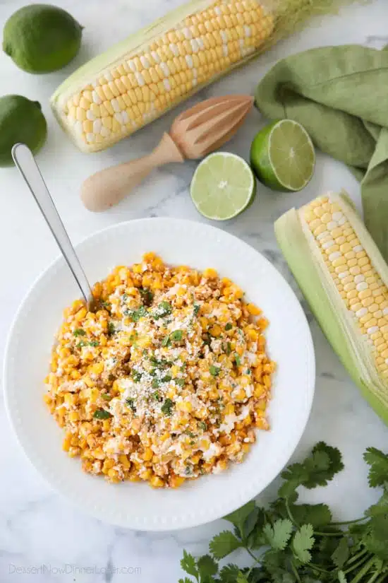 Mexican Street Corn Salad is easy, creamy, and packed with flavor! Your favorite roasted Mexican street corn (Elote) is cut off the cob (to make Esquites) and is served with a spoon, for a delicious summer side dish!