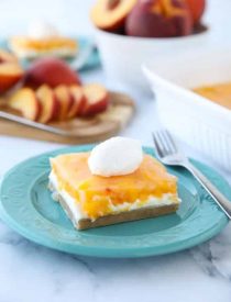 This Peaches and Cream Dessert has a pecan shortbread crust, no-bake cheesecake filling, and fresh peach layer on top. It's a delicious light and fruity summer dessert.