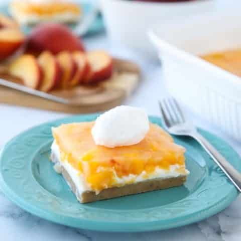 This Peaches and Cream Dessert has a pecan shortbread crust, no-bake cheesecake filling, and fresh peach layer on top. It's a delicious light and fruity summer dessert.