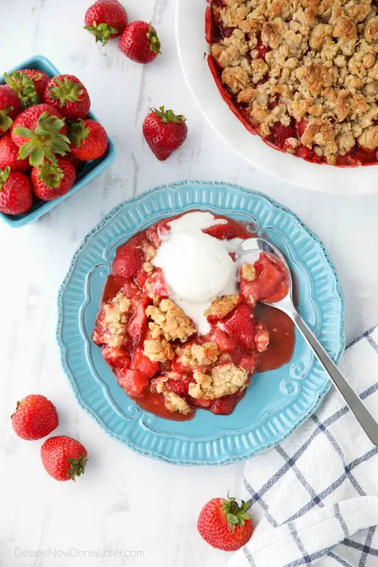 Strawberry Crisp (aka Strawberry Crumble) - Fresh, juicy strawberries are topped with a buttery brown sugar and oat crumb topping. Enjoy this summer dessert warm with a scoop of vanilla ice cream on top! 