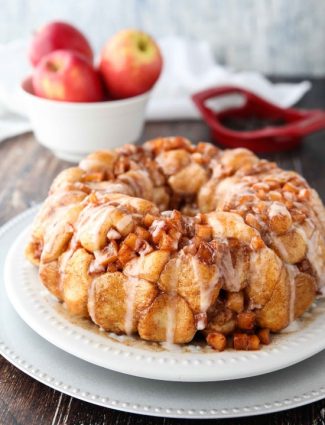 Apple Fritter Monkey Bread is an easy and delicious pull apart bread with chunks of caramelized apples, sticky cinnamon-sugar, and a light glaze. Fashioned after your favorite donut, this apple fritter bread makes a tasty breakfast or dessert.