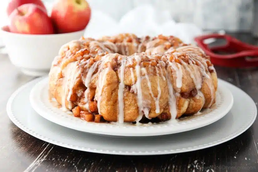 Apple Fritter Monkey Bread is an easy and delicious pull apart bread with chunks of caramelized apples, sticky cinnamon-sugar, and a light glaze. Fashioned after your favorite donut, this apple fritter bread makes a tasty breakfast or dessert.