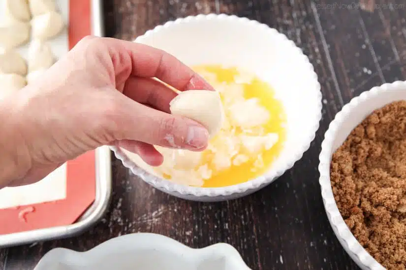 Apple Fritter Monkey Bread - Coating the dough pieces with melted butter.