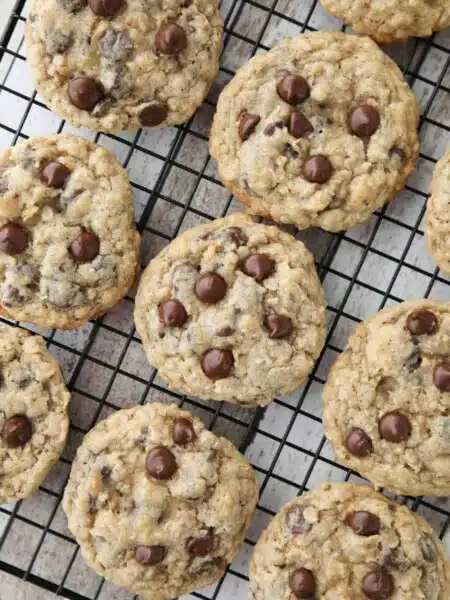 These Oatmeal Chocolate Chip Cookies are thick, soft, and chewy, with plenty of hearty old fashioned oats and creamy chocolate chips. An easy classic recipe.
