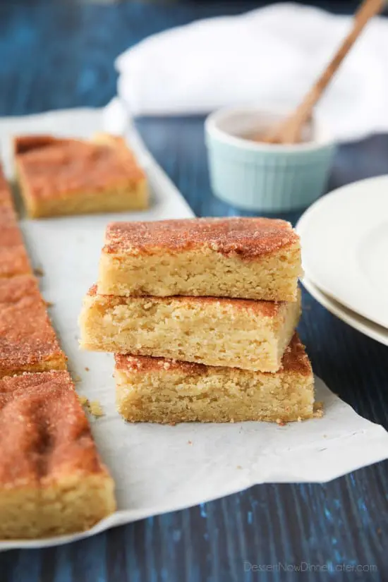 Snickerdoodle Bars transform classic snickerdoodle cookies into easy-to-make blondies. Thick, soft, buttery cookie bars are topped with plenty of cinnamon-sugar. These flavorful, melt-in-your-mouth dessert bars make enough to serve a crowd. Perfect for potlucks, picnics, and parties.