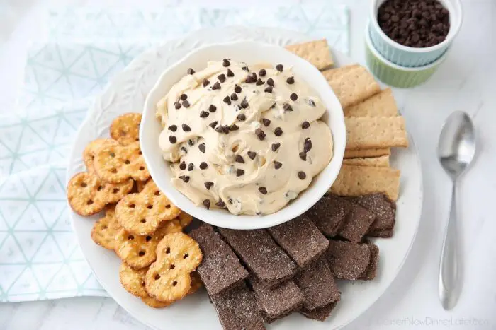 Buckeye Dip is the perfect appetizer or snack for parties, holidays, or game day. This dessert dip is full of peanut butter and chocolate chips and goes well with graham crackers, pretzels, or fruit - like apples.
