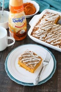 Pumpkin Spice Coffee Cake is easy to make and full of real pumpkin and fragrant spices. It's moist, yet light and fluffy, with a cinnamon crumb topping and pumpkin spice glaze on top.