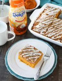 Pumpkin Spice Coffee Cake is easy to make and full of real pumpkin and fragrant spices. It's moist, yet light and fluffy, with a cinnamon crumb topping and pumpkin spice glaze on top.