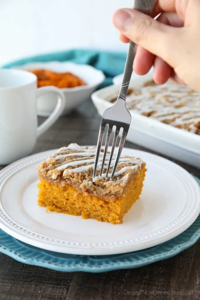 Pumpkin Spice Coffee Cake is easy to make and full of real pumpkin and fragrant spices. It's moist, yet light and fluffy, with a cinnamon crumb topping and pumpkin spice icing on top.