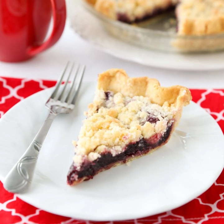 Cherry Crumb Pie can be made with fresh or frozen cherries, flavored with a hint of almond extract, and topped with a sweet crumble topping. Easy and delicious!